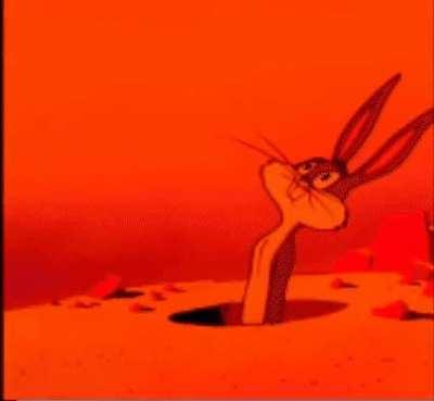 Wile E Coyote's house being blow up by a humongous rocket as Bugs Bunny watches in awe