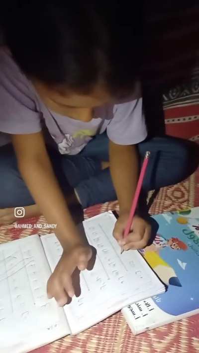 A little girl Sandy from Gaza tries to study Arabic amidst heat, dark and bombings. 