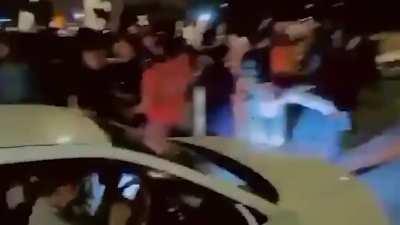 People Dance In Front Of Car, Gets Run Over