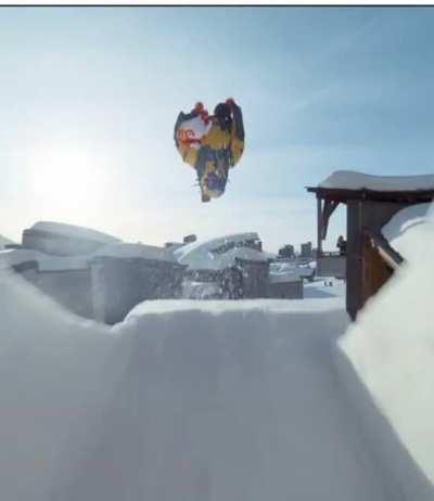 Man skiing down a mountain with the help of a parachute