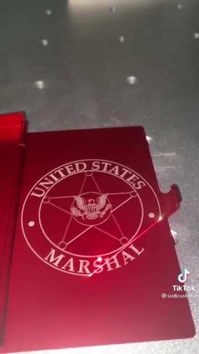 Producing a United States marshal badge with a laser