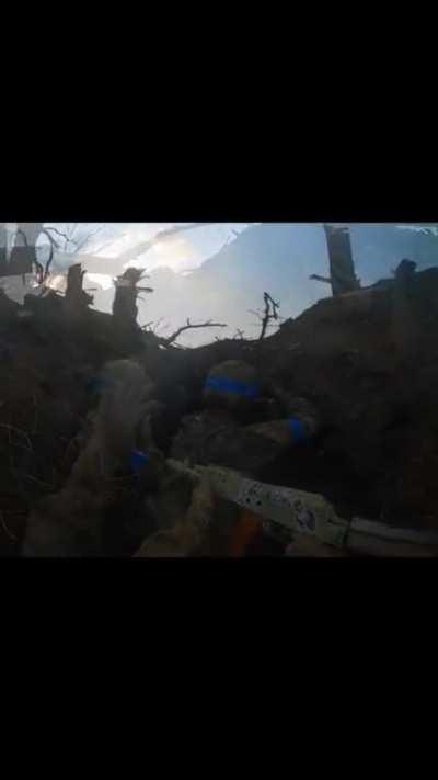 Ukrainian troops storming a russian trench in the Donetsk region and taking a prisoner.