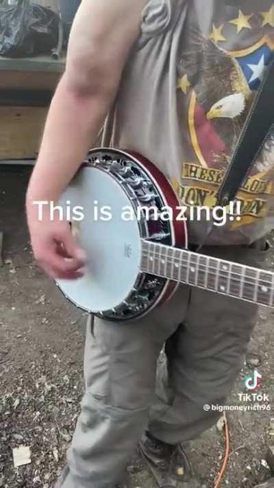 Man plays banjo with broken arm