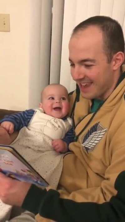 Daddy reading a book to his daughter in different voices