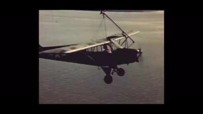 This is a video of the Brodie System being used on the L-5 Sentinel Aircraft during WWII. The Brodie system was a way to launch and recover aircraft from a ship, without having to convert the ship to have a flight deck, and without using seaplanes.