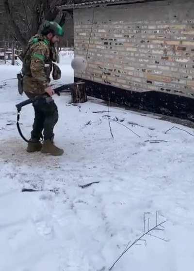 Ukrainian soldier letting off some steam with a football after repelling the Russians in no man's land