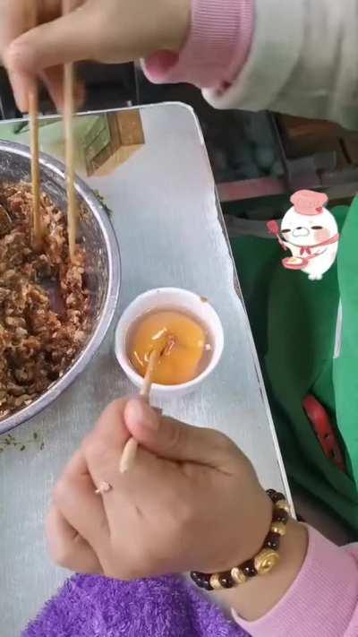 Making an egg wrapped dumpling