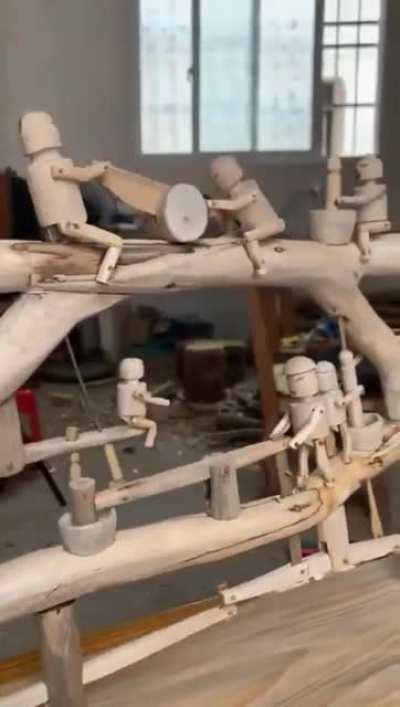 A group of artisans made a working model of wooden artisans working.