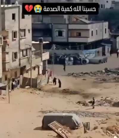 Palestinian Child injured in the middle of the street. Civilians gather to try to help, Israel airstrikes the civilians 