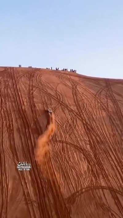 Driving up a sand dune