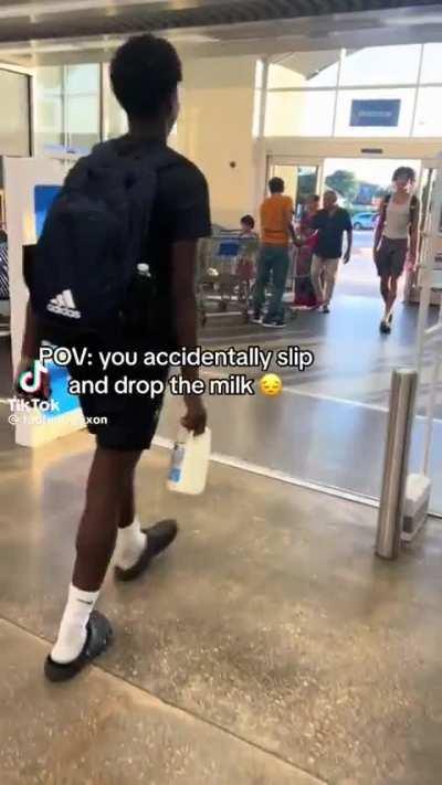 People's &quot;accidentally&quot; spill milk by the entrance of a Walmart 