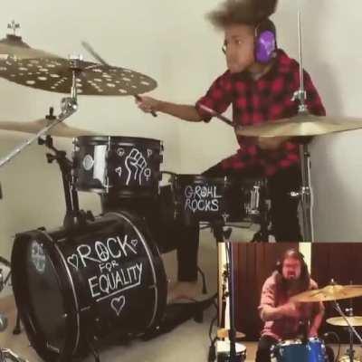 Young girl plays along with drummer Dave Grohl and keeps up