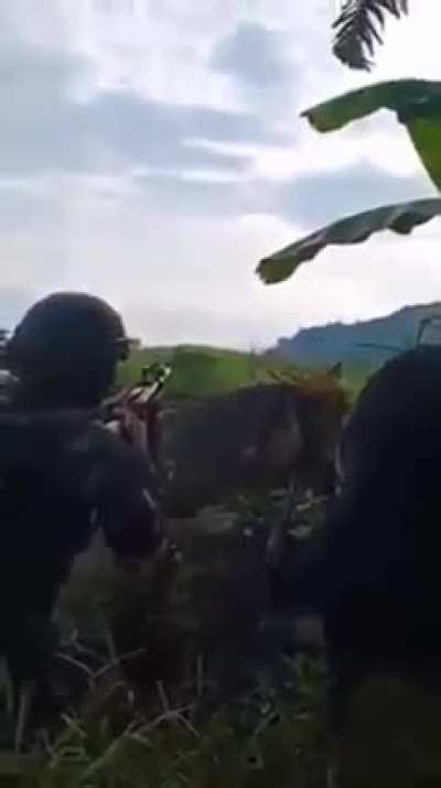 A Filipino soldier fires his M79 grenade launcher towards the enemy during an encounter with NPA communist rebels, Negros Occidental, Philippines, 2021.