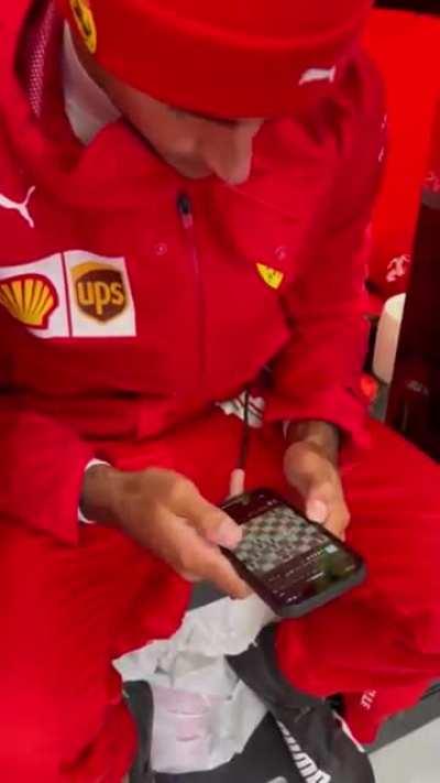 F1 drivers Charles Leclerc and Carlos Sainz playing chess while waiting for the start of the 2021 Belgian Grand Prix