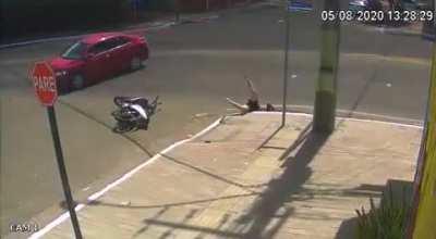 Biker crashes into car and falls into sewage