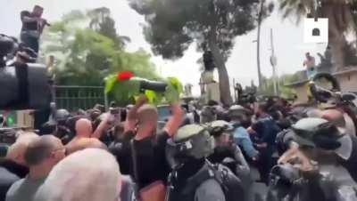 Israeli forces rip Palestinian flags from hearse of Shireen Abu Akleh, Palestinian-American journalist targeted and killed by an Israeli sniper despite wearing press gear [5/13/22]