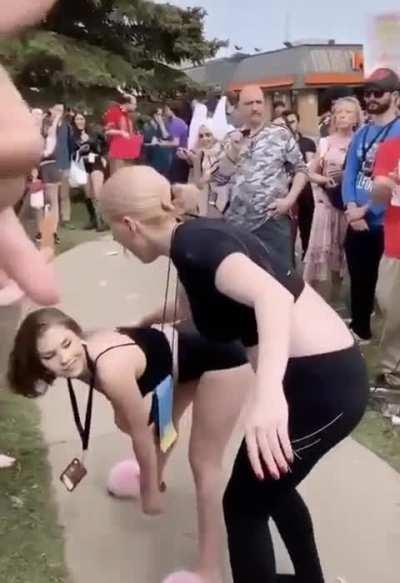 Girl twerks at group of people protesting against an anime convention