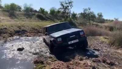 Me attempting some wet action. this Water/mud definitely affected my old girl. Headlights were on and off the entire way home. Guess I'll have to do some fault finding.