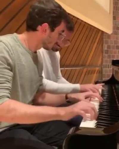 These brothers playing the piano