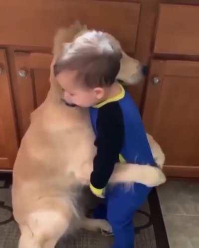 Aww...the dog actually hugged him back