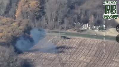 Russian armored vehicles suppress a position and deliver troops there while under fire from FPV drones, near Petrivka