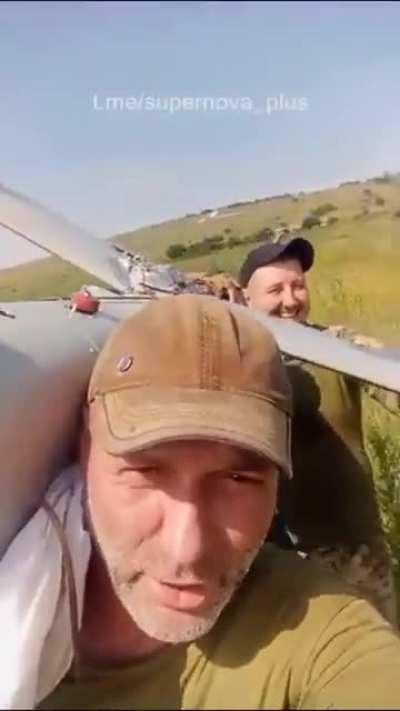 Two Ukrainian soldiers appear cheerful after getting their hands on a trophy Orlan-10 Russian reconnaissance drone