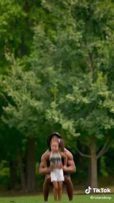 Dad and daughter practicing cheerleading