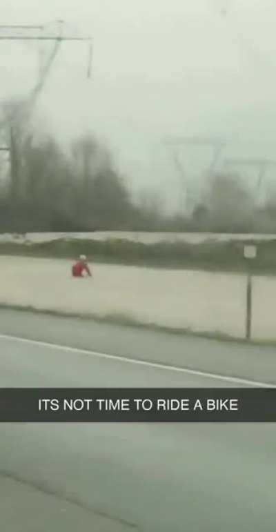 Saw this dedicated cyclist on his commute home during a flood. Rain or shine!