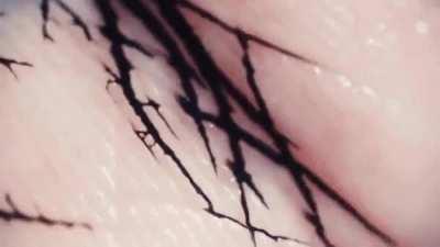 Closeup of ink flowing across the skin