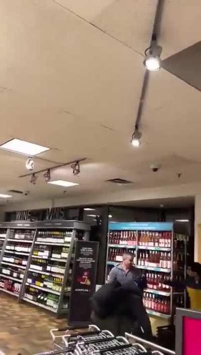 Customer attempts to stop a liquor store robbery. Guy filming shouts “Let em go”. Owner said they got away with over $3000 worth of alcohol. (Canada) 