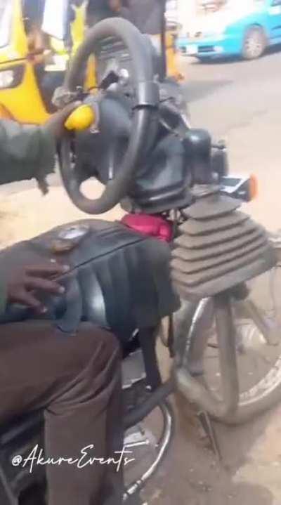 This guy modified his motorbike to have a gear, acceleration foot pedal and a steering wheel like a car