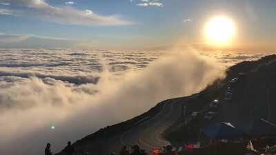 Clouds crashing into pikes peak like waves in the ocean