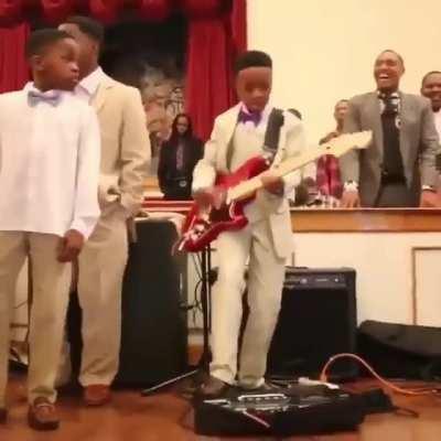 Proud father goes crazy over his son's perfect guitar performance