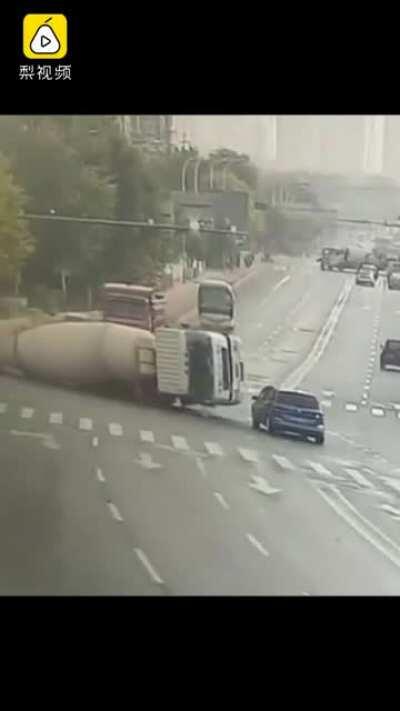 Driver hesitates in front of a concrete mixer