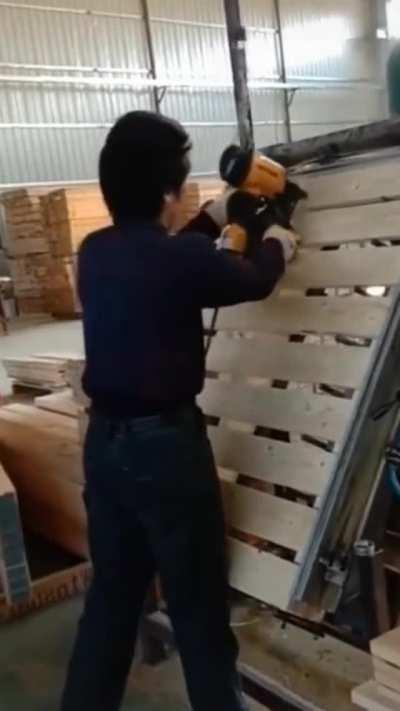 Man making wood pallets with precision aim