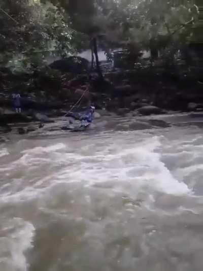 Girls crossing the river to go to the school