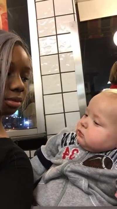 Baby stares at women then smirks