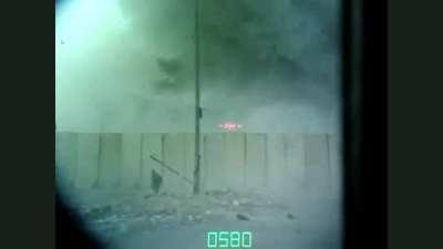 In Sadr city, a United States M1 Abrams Tank crew records an airstrike right in front of their tank through the gunsights. (Baghdad, Iraq)