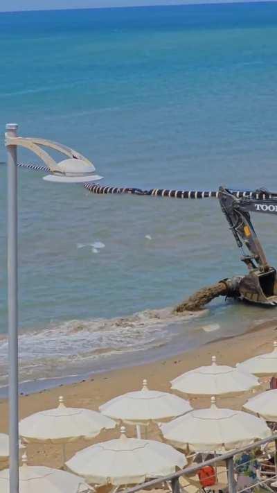 Dredging ship restores an eroded beach