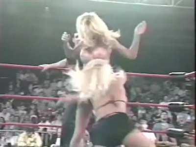 Getting her top removed during a wrestling match