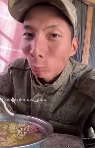 KPA soldier in Russian uniform recordin what looks like a Mukbang video. 