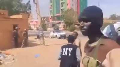 Sudanese soldiers shooting at a passing RSF member on a motorcycle