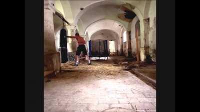 Jiri trains in empty castle with trampoline and hay on ground