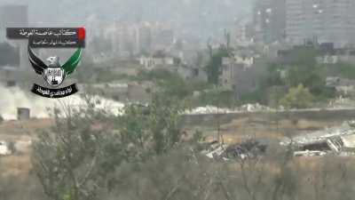 Ghouta Mujahedeen Brigade recoilless team scores a remarkable hit on a swiftly moving Syrian Army T-72 - Ghouta - 6/24/2013