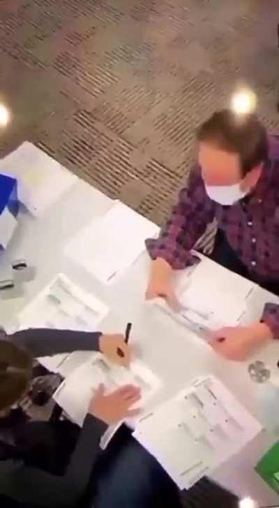 VIDEO poll worker filling out ballots with security guard totally aware!