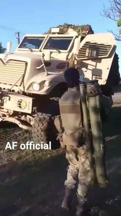 UKrainian soldier carrying an AT launcher enthusiastically shows off his MRAP
