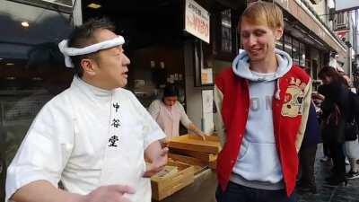 Bucket drummer drums to the beat of mochi making masters of Nara.