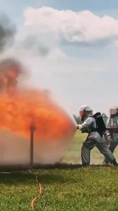 Firefighters use Water shield to completely block flames behind water curtain