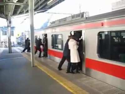 Tokyo Subway's professional train pushers at work