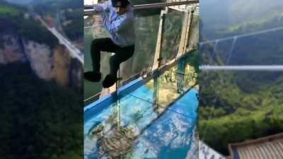 This glass bridge in China, that is thousands of feet high, has a breaking effect when stepped on